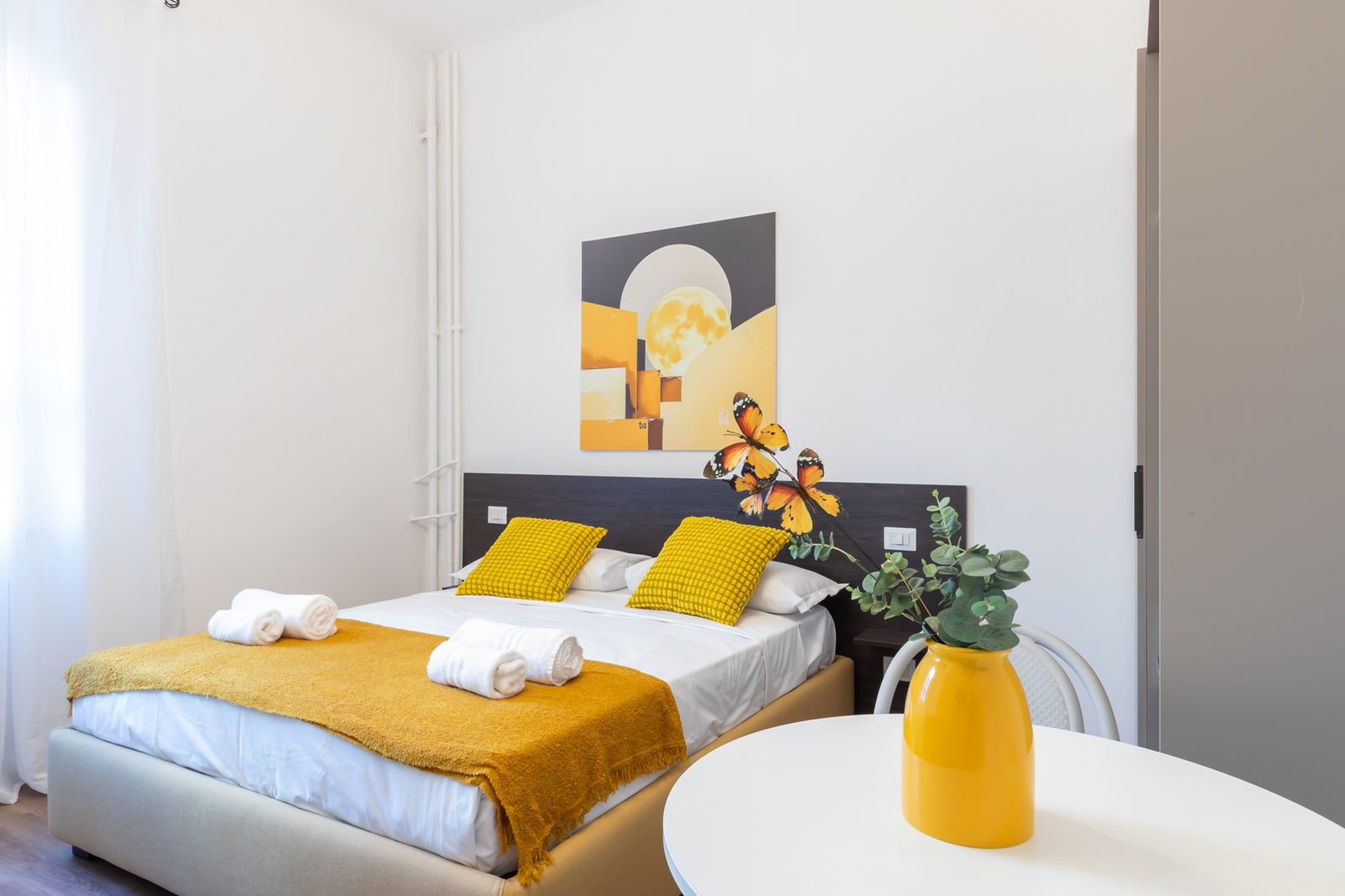 Studio at Moon Apartments with a double bed and yellow accents